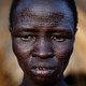 A Sudanese woman with ethnic Nuer tribal scarification in the town of Malakal in Upper Nile state, April 10, 2010. The Nuer receive facial markings during initiation into adulthood.